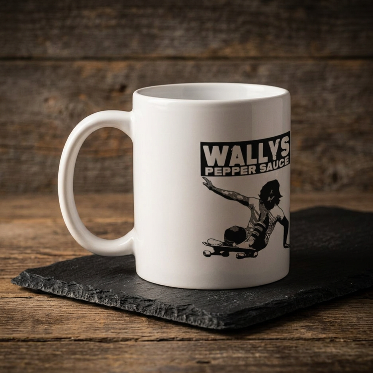 Wallys Pepper Sauce 11oz mug, left side, on black slate on a wood table