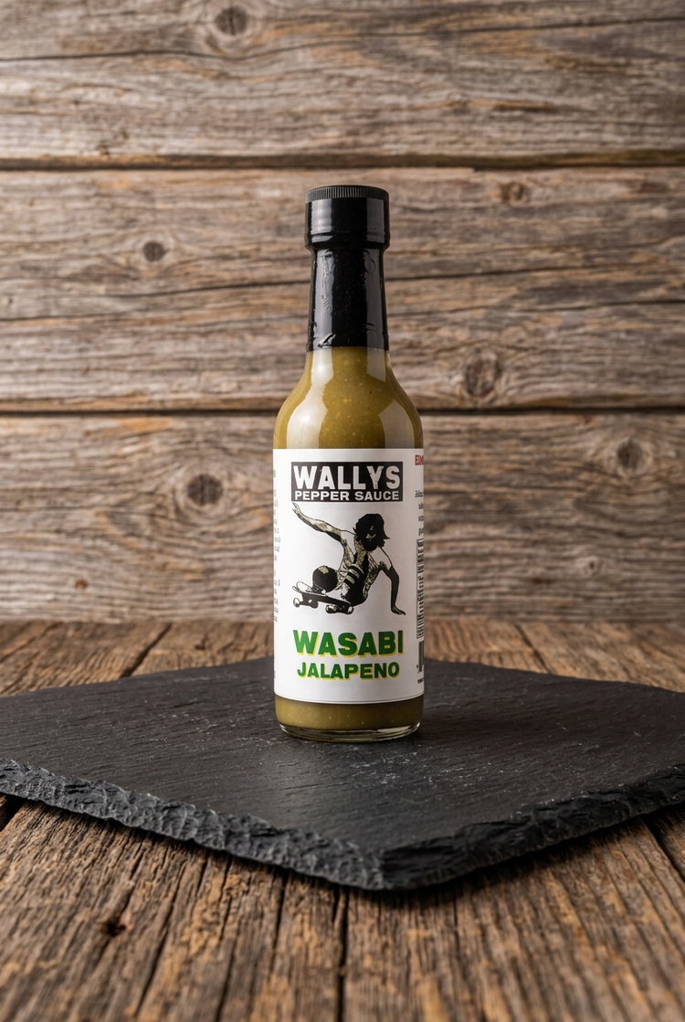 Wasabi Jalapeño pepper sauce bottle on black slate on a wood table